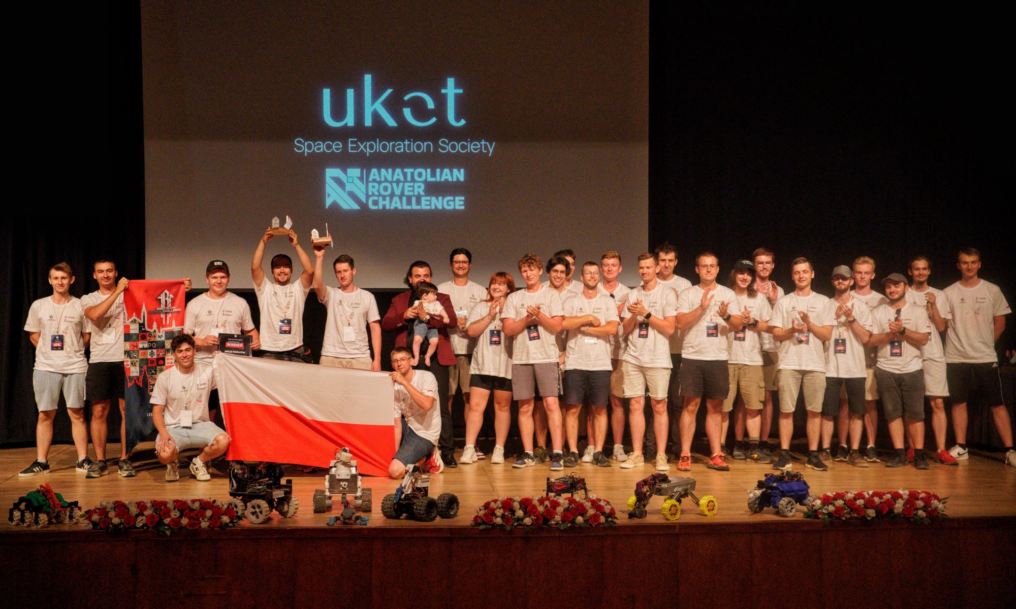 Zespół LRT na scenie w tle napis UKET / LRT team on stage with UKET sign in the background
